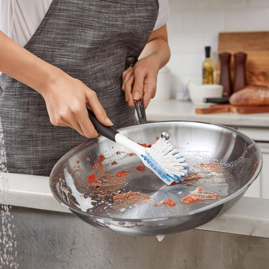 flared, angled brush head shaped to clean corners of pans, jars, and bottles