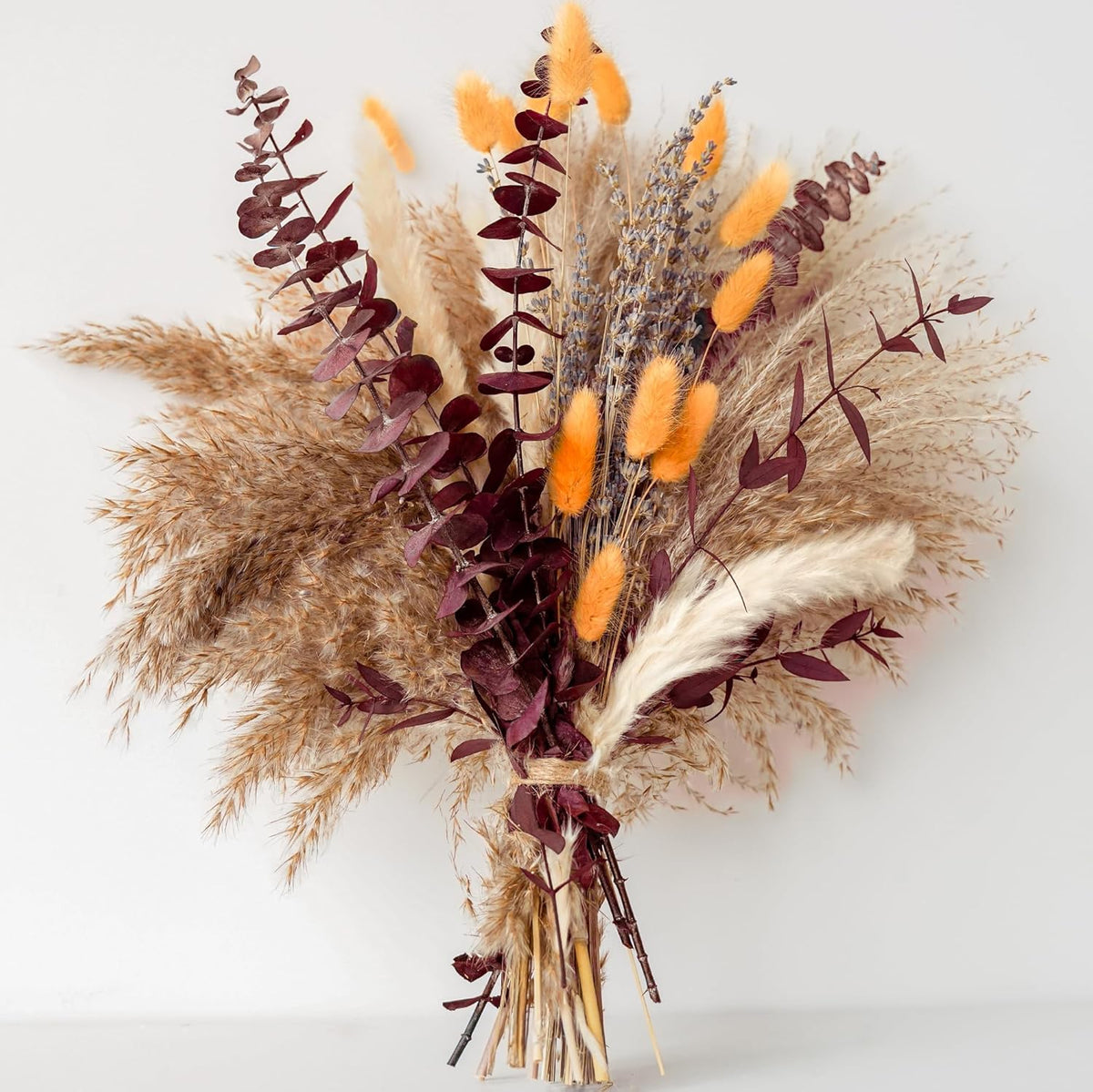 real dried pampas grass, orange bunny tails, lavender, and red eucalyptus stems